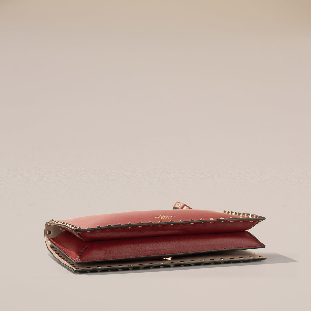 Valentino Garavani Rockstud Wristlet Clutch, Red Calfskin — base, angle