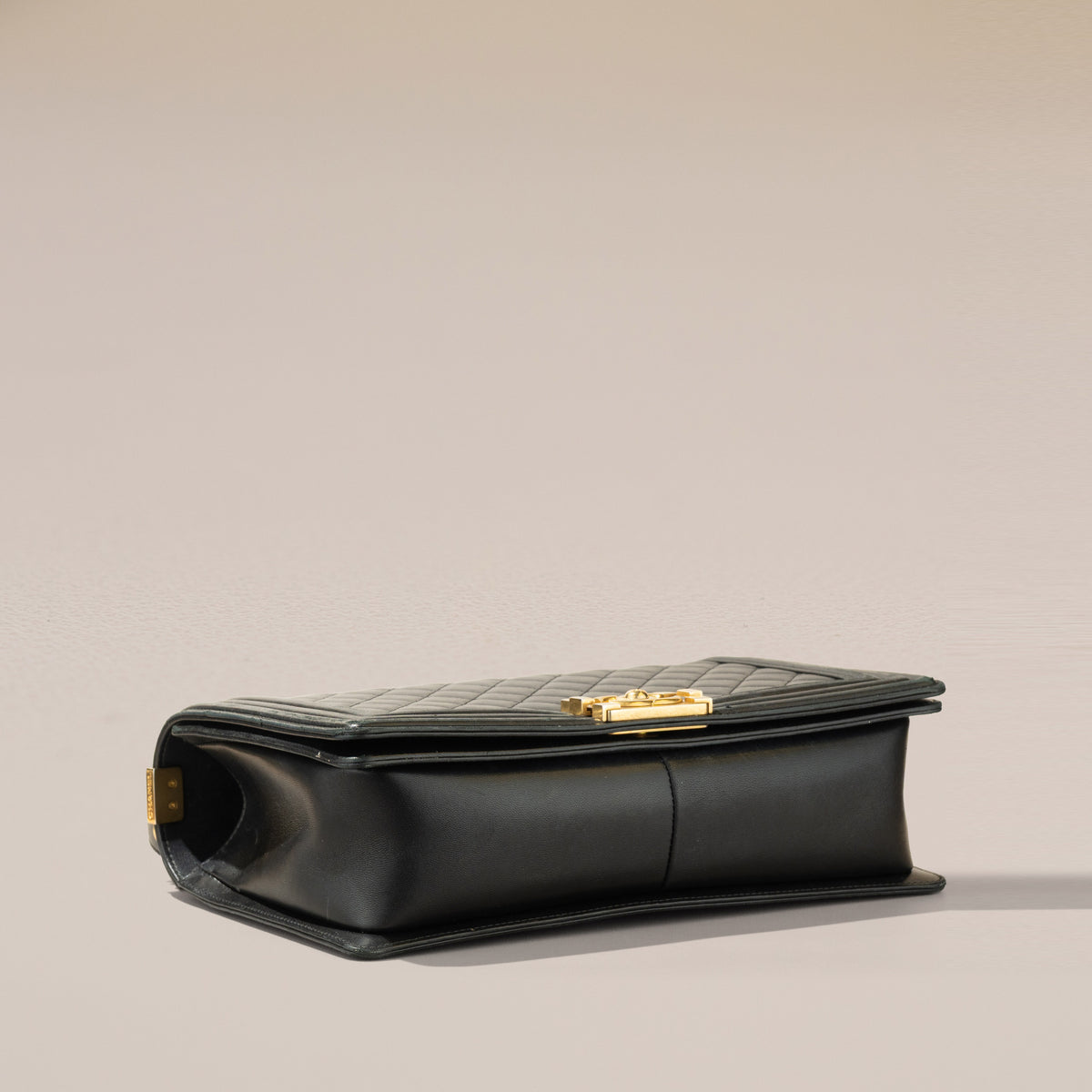 Chanel New Medium Boy Bag, Black Lambskin — base, angle
