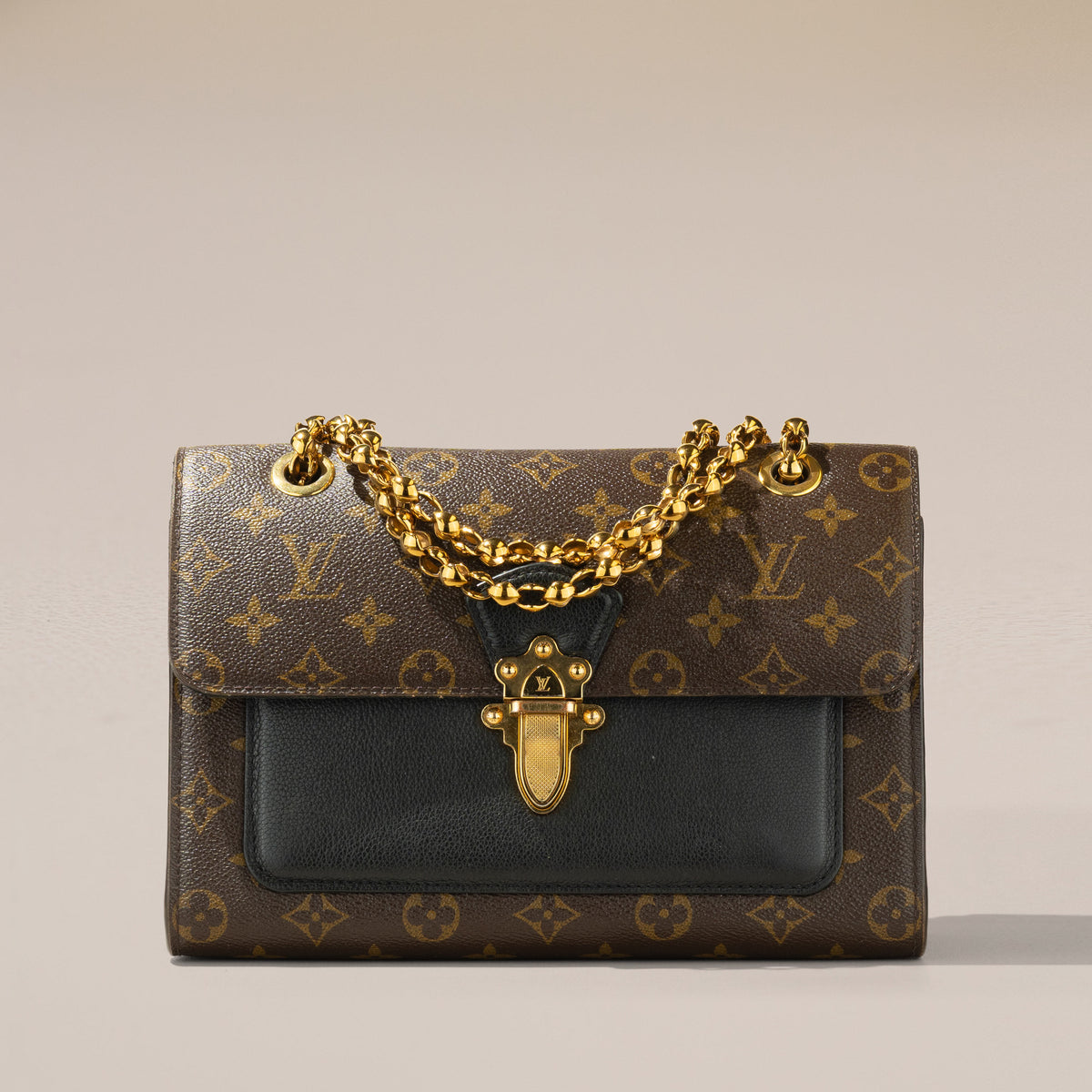 Louis Vuitton Victoire, Monogram and Black Leather — chain draped